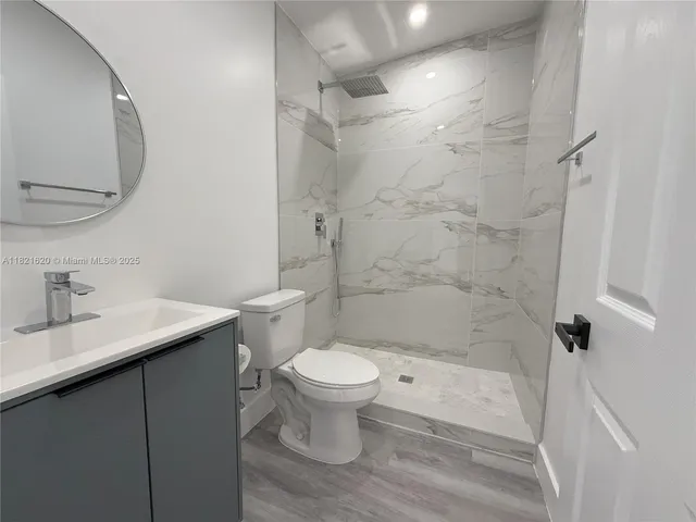a bathroom with a sink toilet and shower