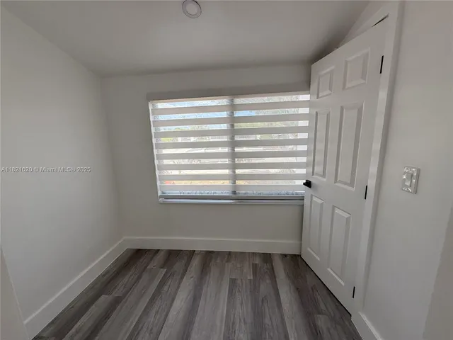 a view of room with window and hardwood floor