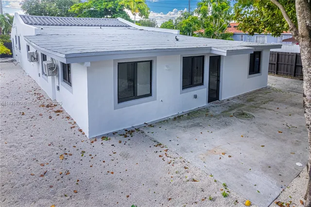 a view of a house with a backyard