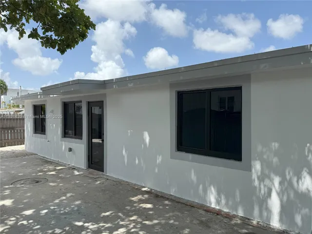 a view of a brick house with a large window