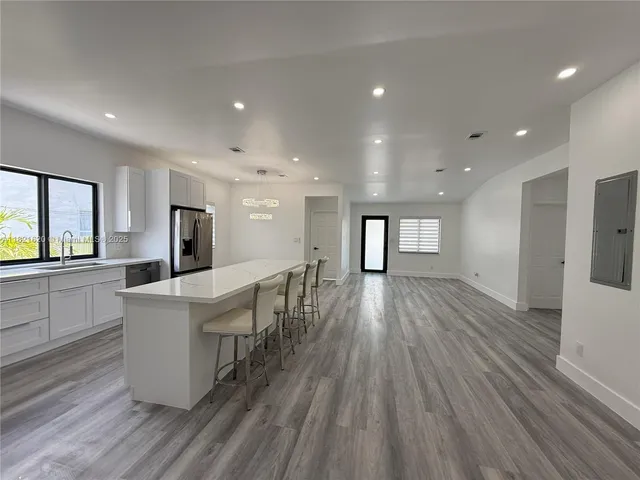 a view of kitchen with cabinets and wooden floor