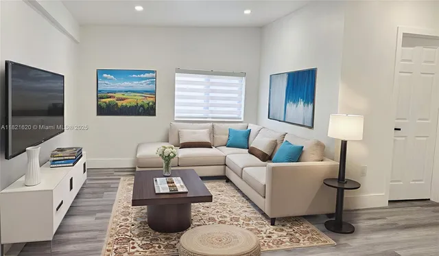 a living room with furniture and a flat screen tv