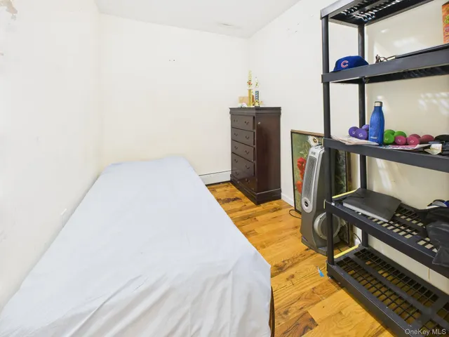 a bed sitting in a bedroom next to a window
