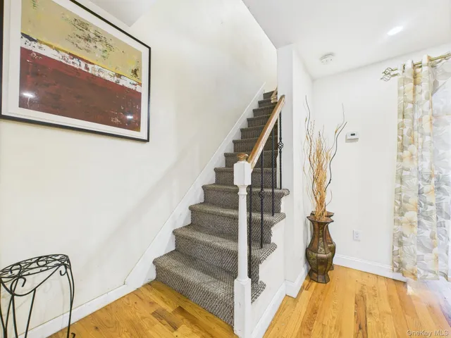 a view of a room with wooden floor and windows