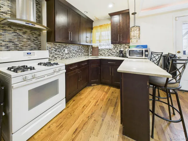 a kitchen with a stove a sink and a microwave
