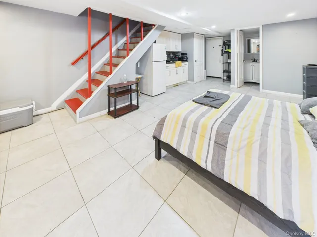 a bedroom with a bed closet and stairs