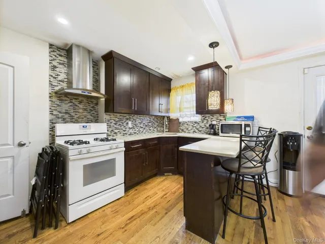 a kitchen with a stove a sink and a refrigerator