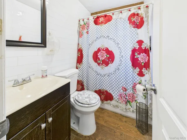 a bathroom with a sink mirror and toilet
