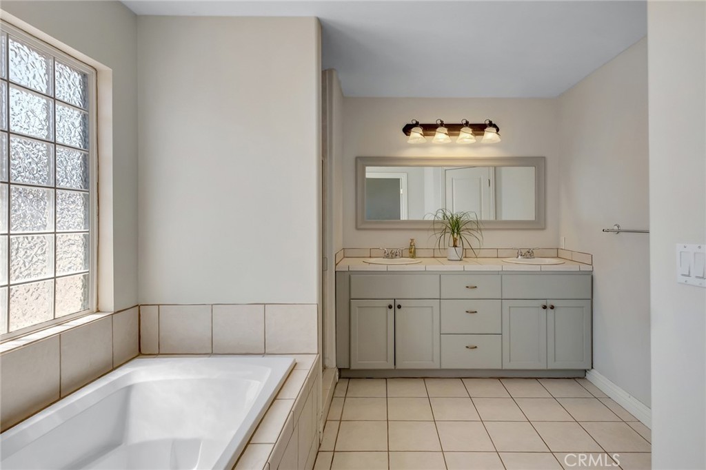 14952 Rivers Edge Road Helendale, CA 92342 - Photo 26 of 33 a spacious bathroom with a granite countertop sink and a mirror