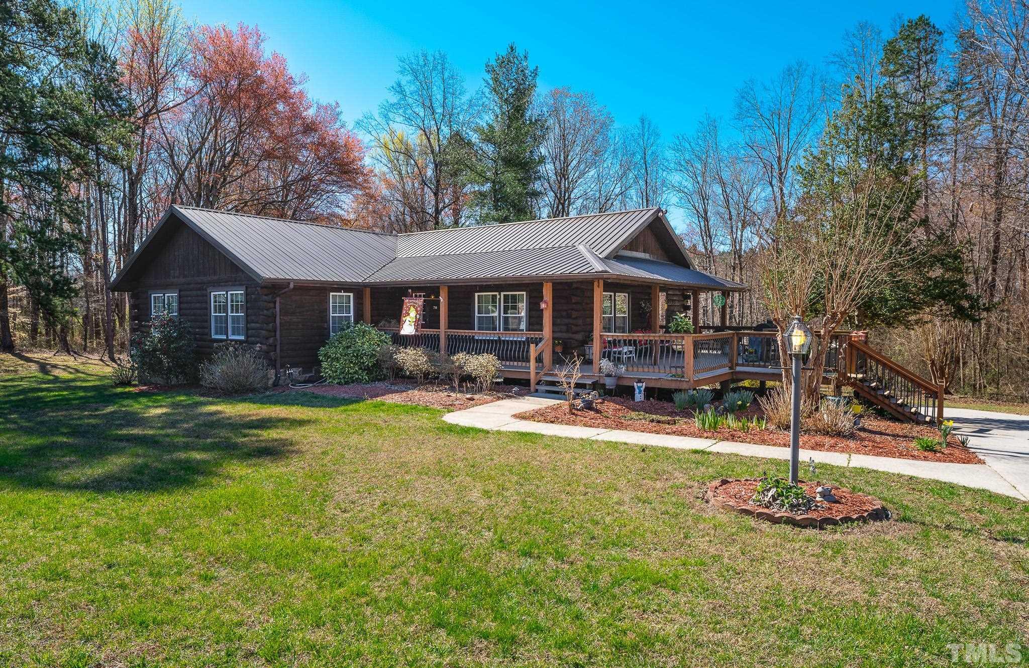 714 Lucy Garrett Road Roxboro, NC 27574 - Photo 1 of 68 a front view of a house with yard patio and green space