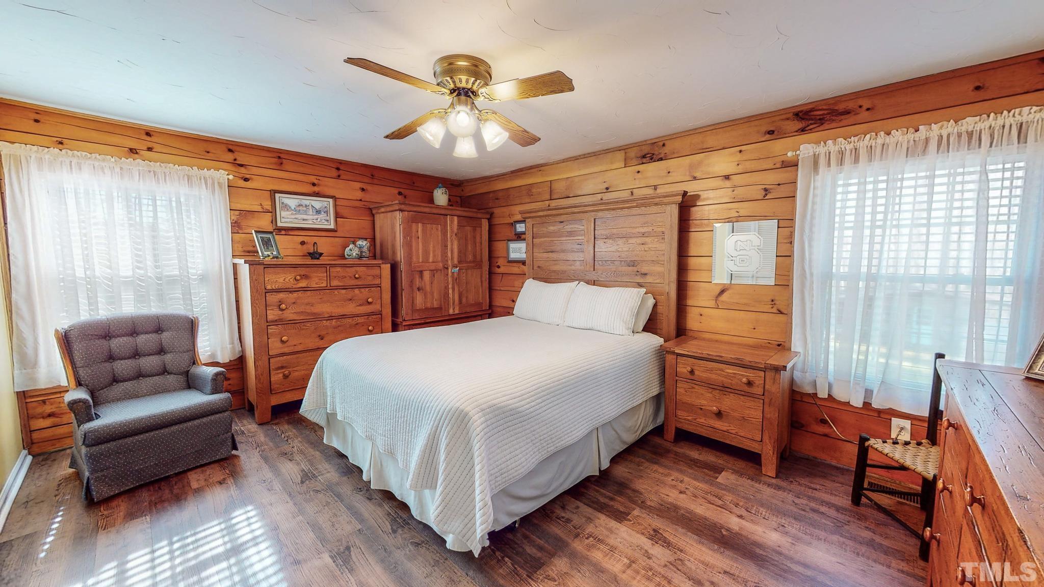 714 Lucy Garrett Road Roxboro, NC 27574 - Photo 16 of 68 a bedroom with a bed and wooden floor