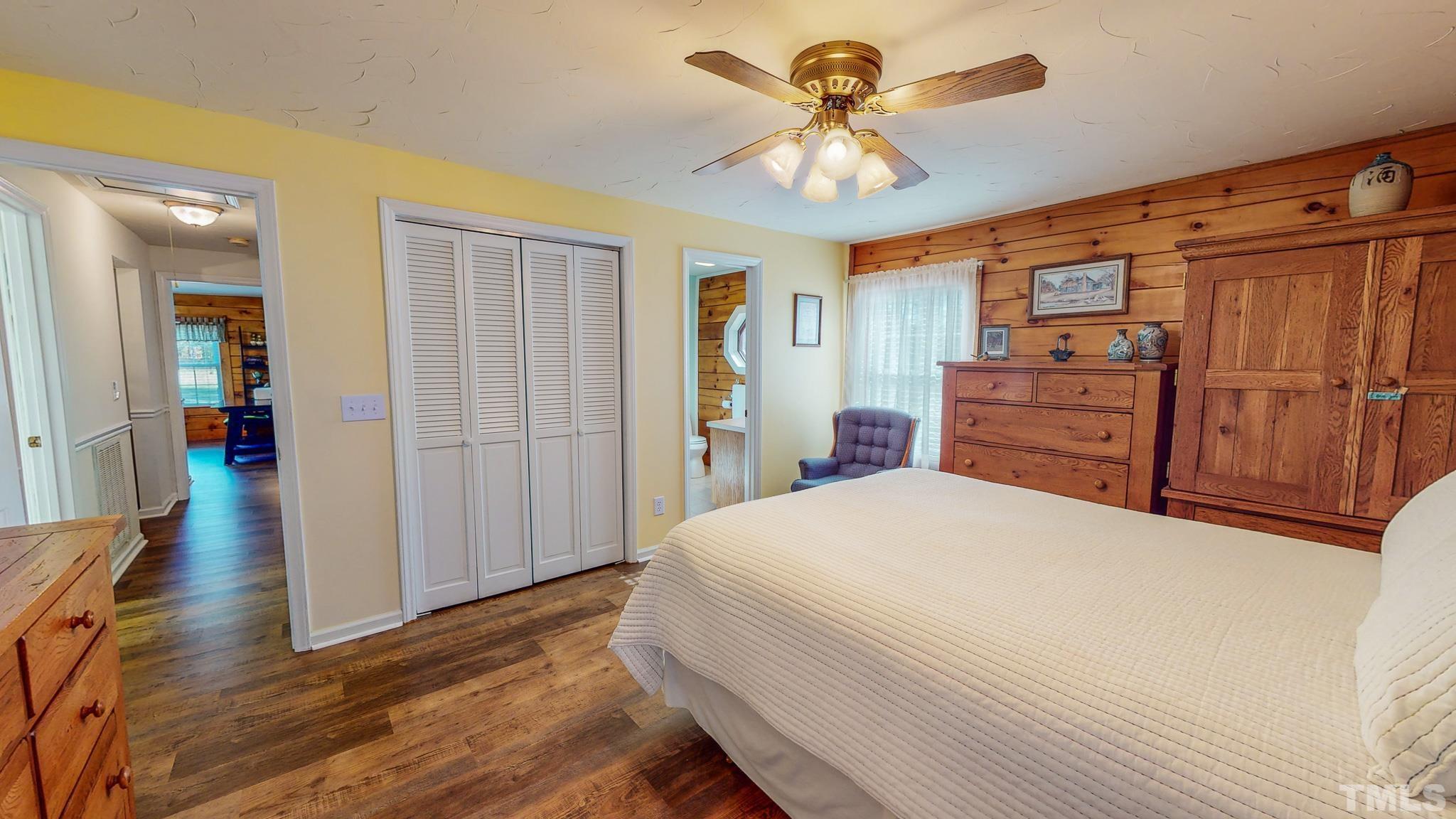 714 Lucy Garrett Road Roxboro, NC 27574 - Photo 17 of 68 a bedroom with a bed and a chandelier