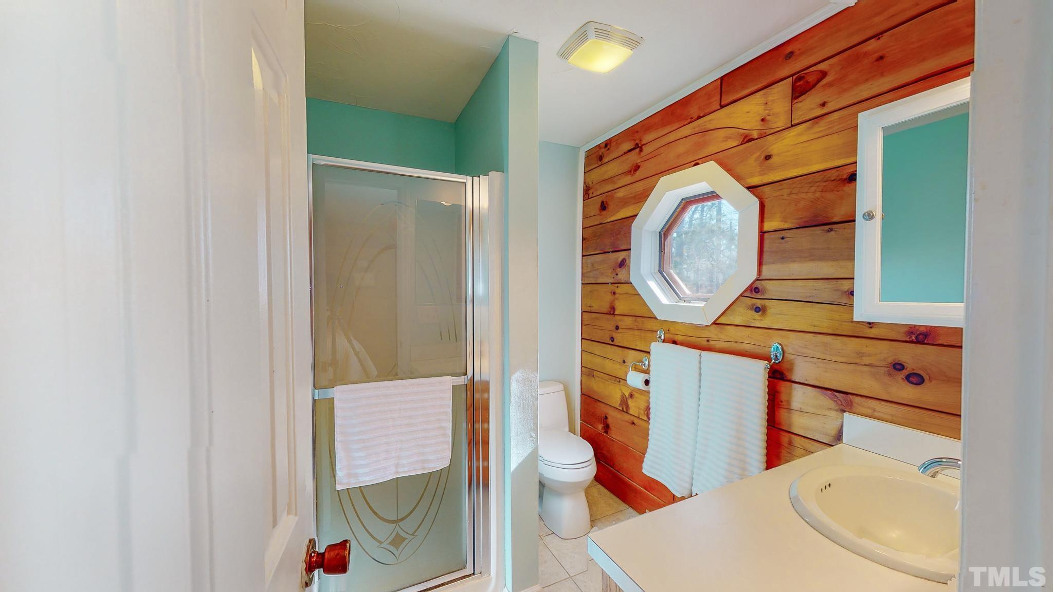 714 Lucy Garrett Road Roxboro, NC 27574 - Photo 18 of 68 a bathroom with a toilet a sink and a mirror