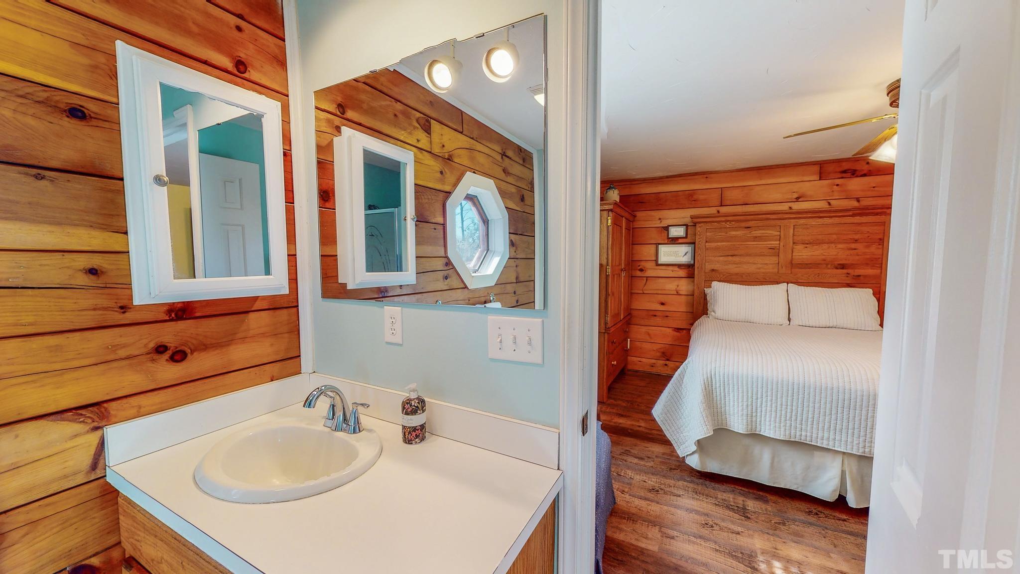 714 Lucy Garrett Road Roxboro, NC 27574 - Photo 19 of 68 a en suite bathroom with a sink and mirror
