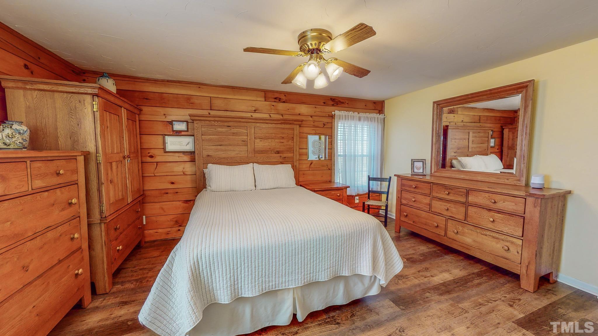 714 Lucy Garrett Road Roxboro, NC 27574 - Photo 20 of 68 a bedroom with a bed and a chandelier