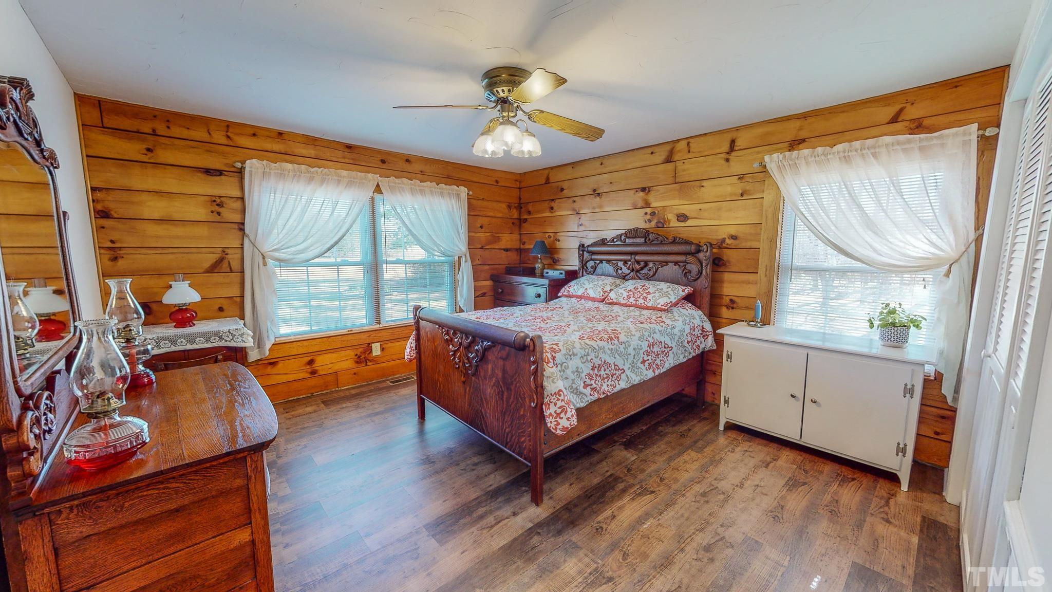 714 Lucy Garrett Road Roxboro, NC 27574 - Photo 23 of 68 a bedroom with a bed and a chandelier