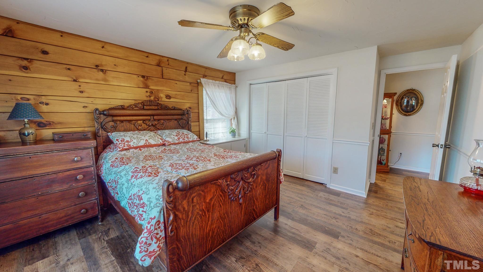 714 Lucy Garrett Road Roxboro, NC 27574 - Photo 24 of 68 a bed sitting in a bedroom next to a window and a chandelier