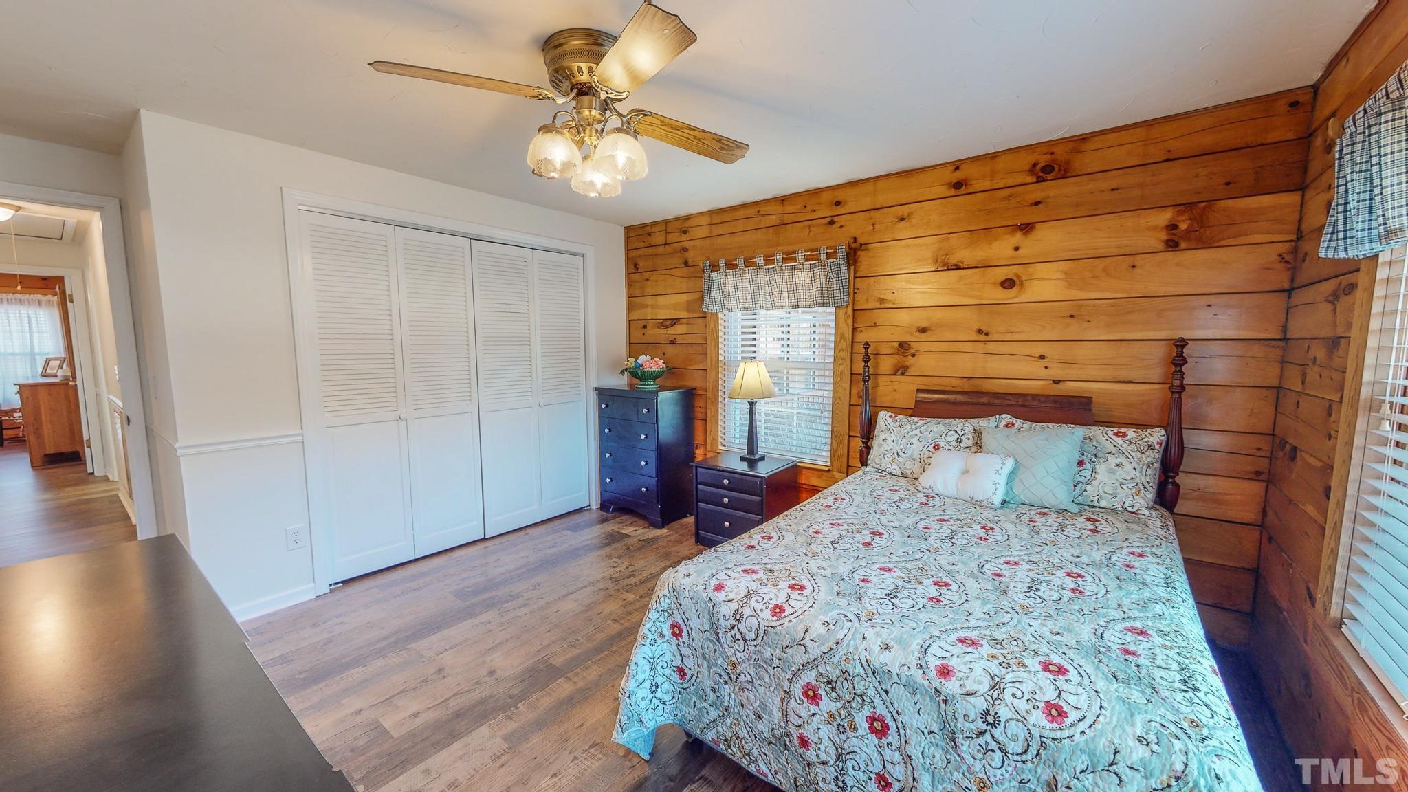 714 Lucy Garrett Road Roxboro, NC 27574 - Photo 26 of 68 a bedroom with a bed and a chandelier