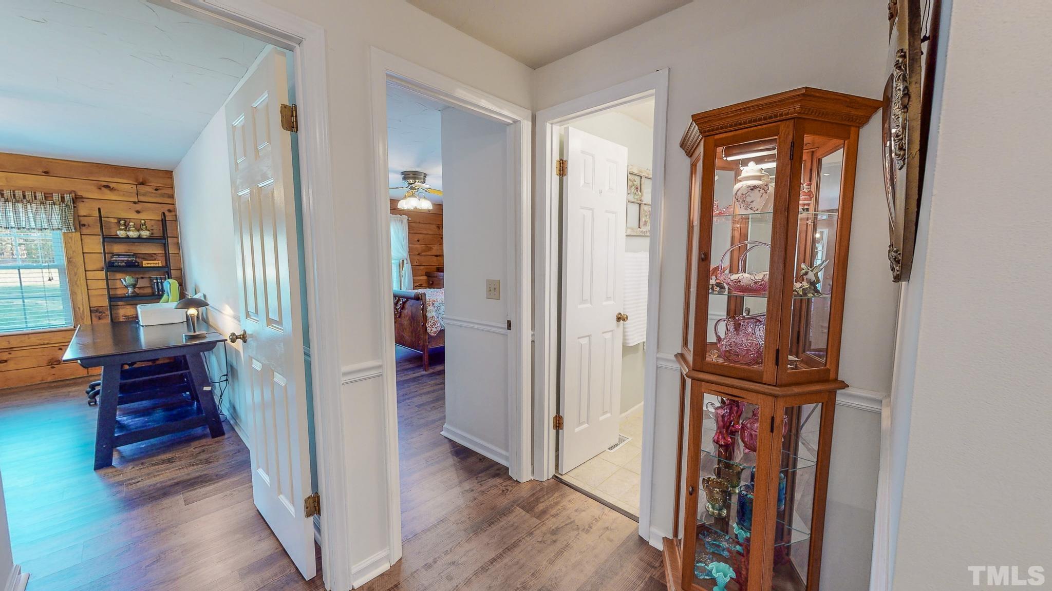 714 Lucy Garrett Road Roxboro, NC 27574 - Photo 27 of 68 a view of a hallway with wooden floor and windows