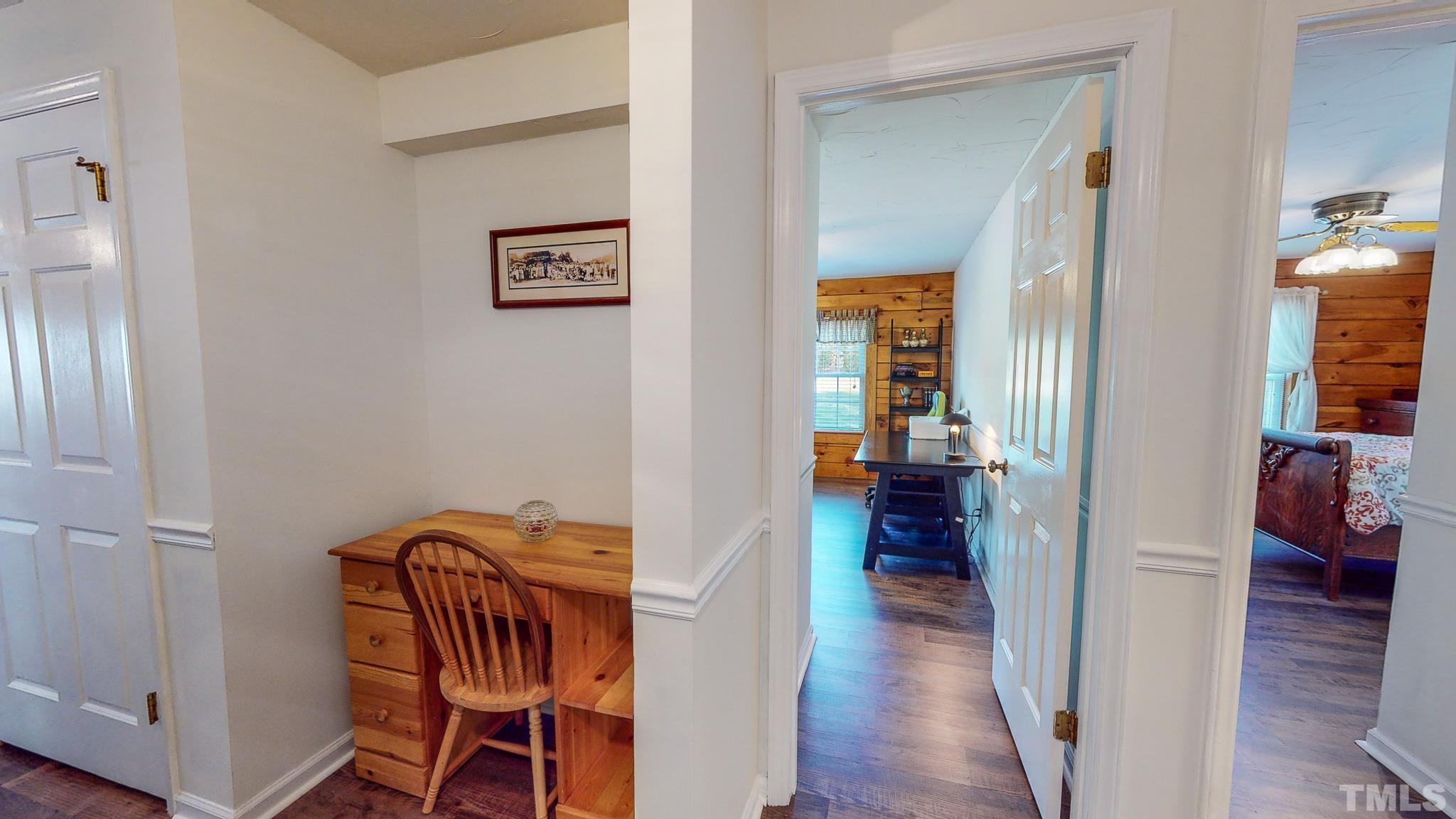 714 Lucy Garrett Road Roxboro, NC 27574 - Photo 29 of 68 a view of a hallway with wooden floor windows and a livingroom