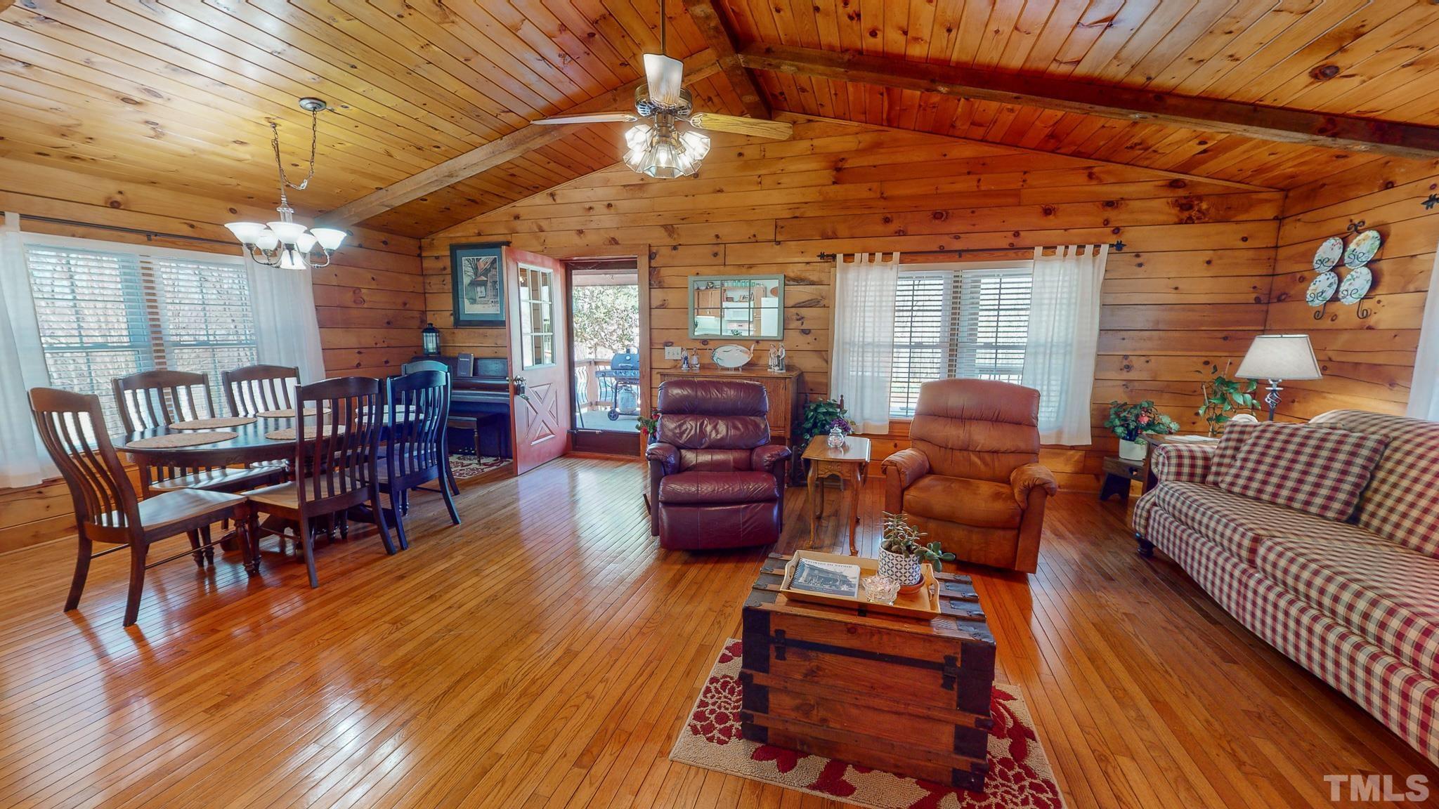 714 Lucy Garrett Road Roxboro, NC 27574 - Photo 36 of 68 a outdoor living space with furniture and wooden floor