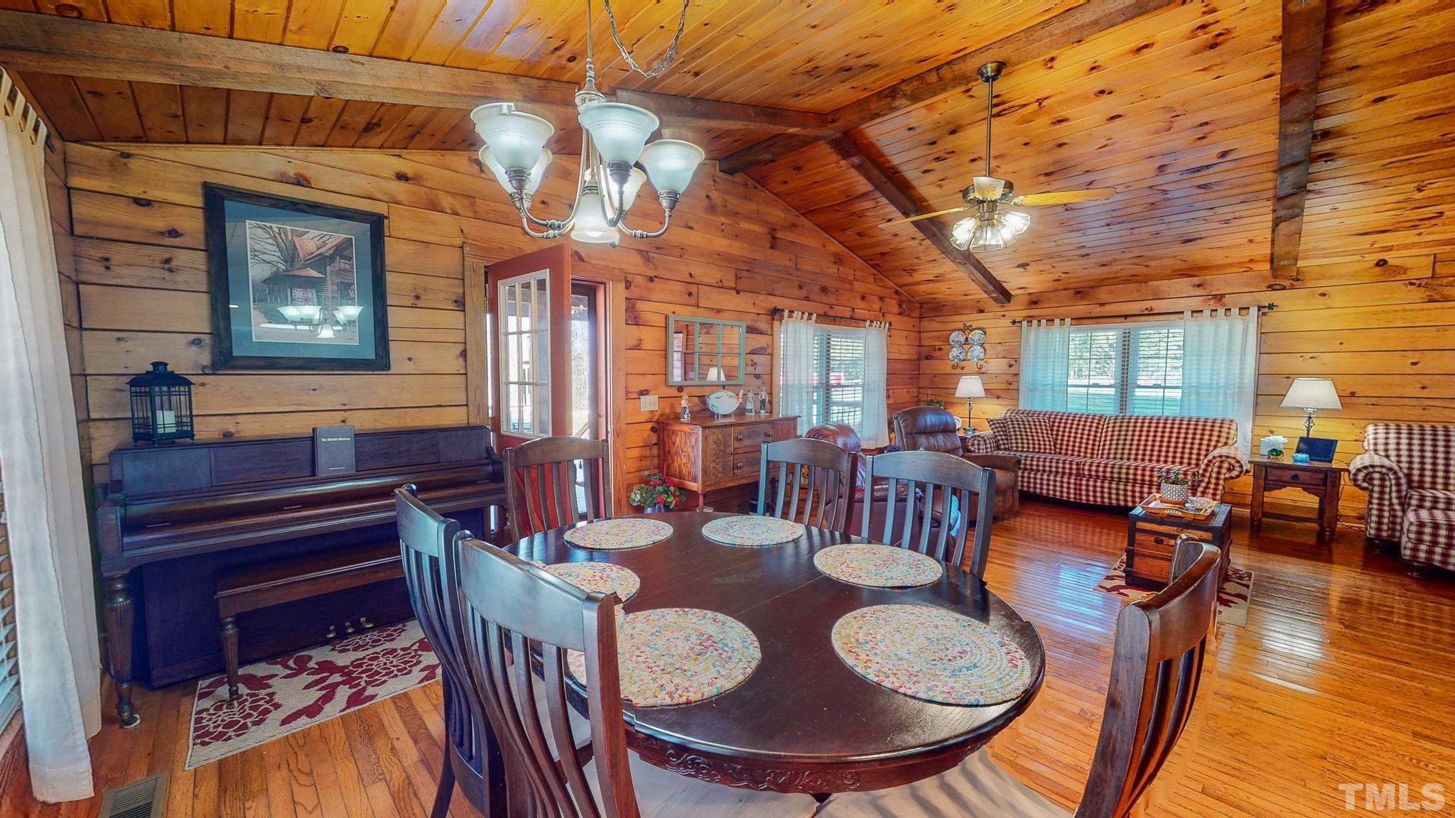 714 Lucy Garrett Road Roxboro, NC 27574 - Photo 38 of 68 a view of a dining room with furniture window and wooden floor