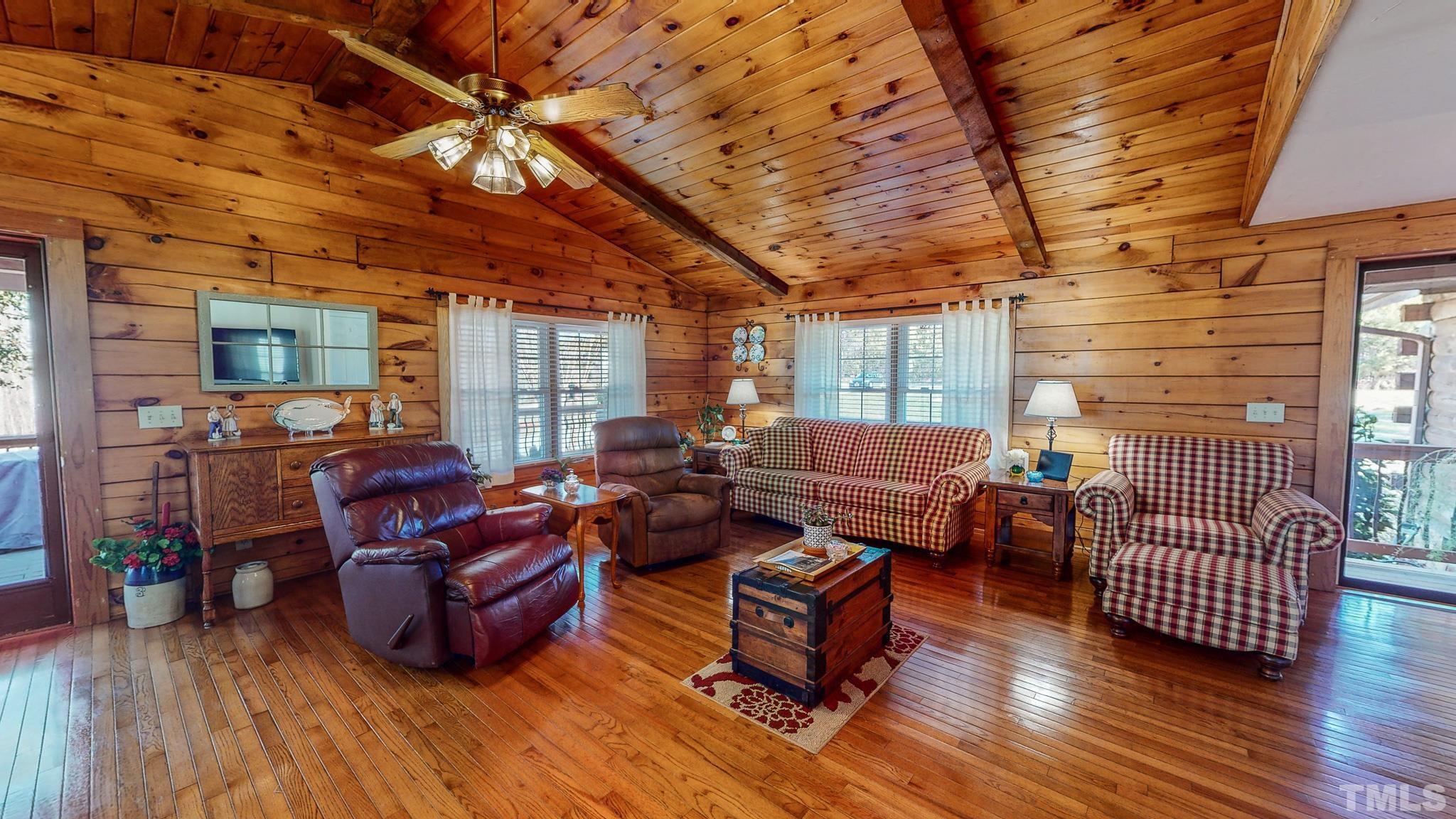 714 Lucy Garrett Road Roxboro, NC 27574 - Photo 39 of 68 a living room with furniture and a wooden floor