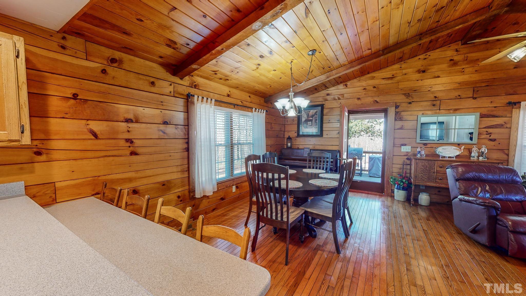 714 Lucy Garrett Road Roxboro, NC 27574 - Photo 44 of 68 a view of a dining room with furniture and wooden floor