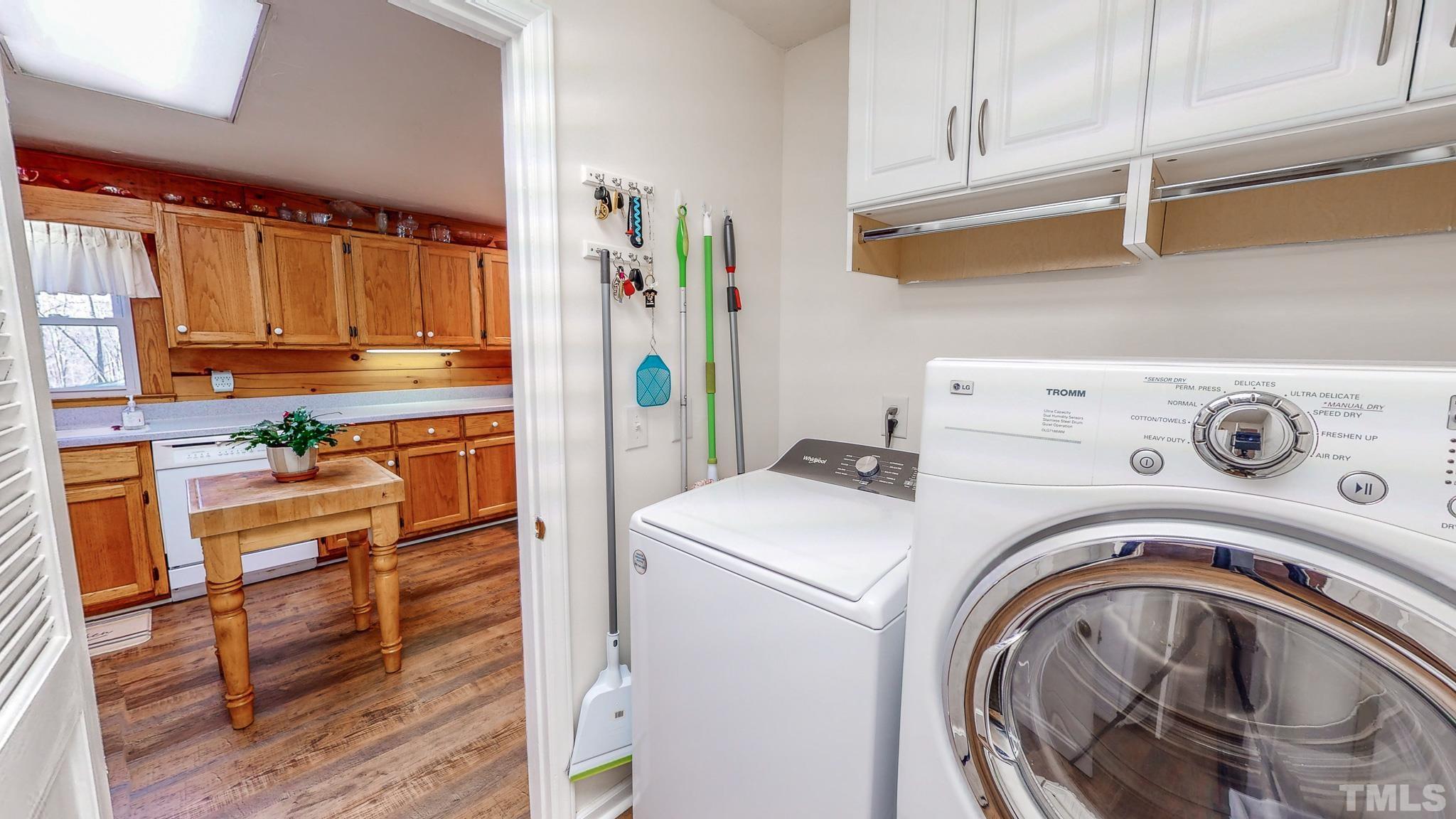 714 Lucy Garrett Road Roxboro, NC 27574 - Photo 46 of 68 a view of washer and dryer with kitchen in the background