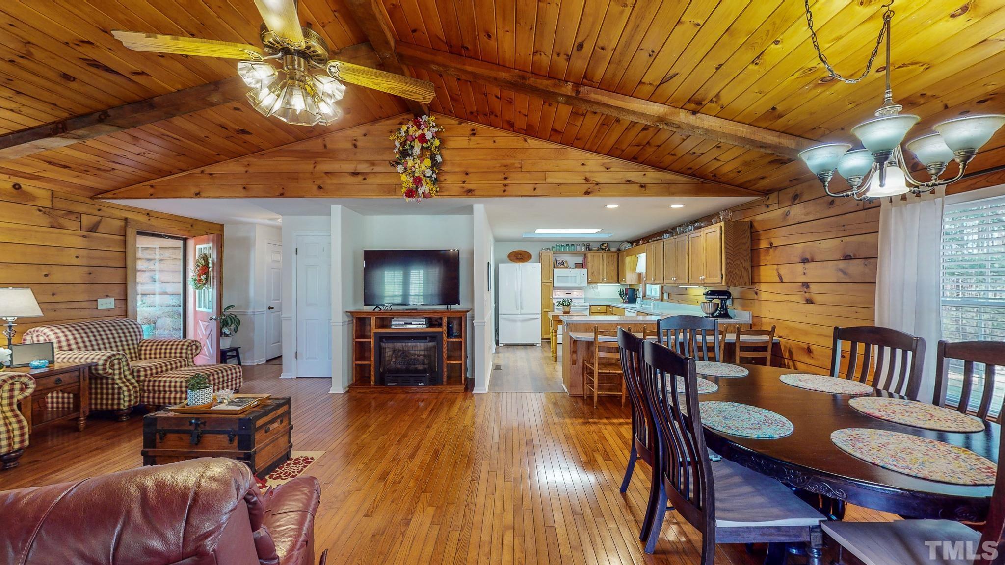 714 Lucy Garrett Road Roxboro, NC 27574 - Photo 50 of 68 a view of a dining room with furniture window and wooden floor
