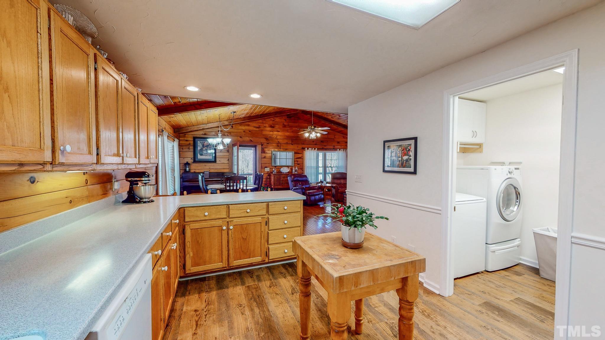 714 Lucy Garrett Road Roxboro, NC 27574 - Photo 5 of 68 a kitchen with stainless steel appliances granite countertop a refrigerator a sink dishwasher a stove and white countertops with wooden floor