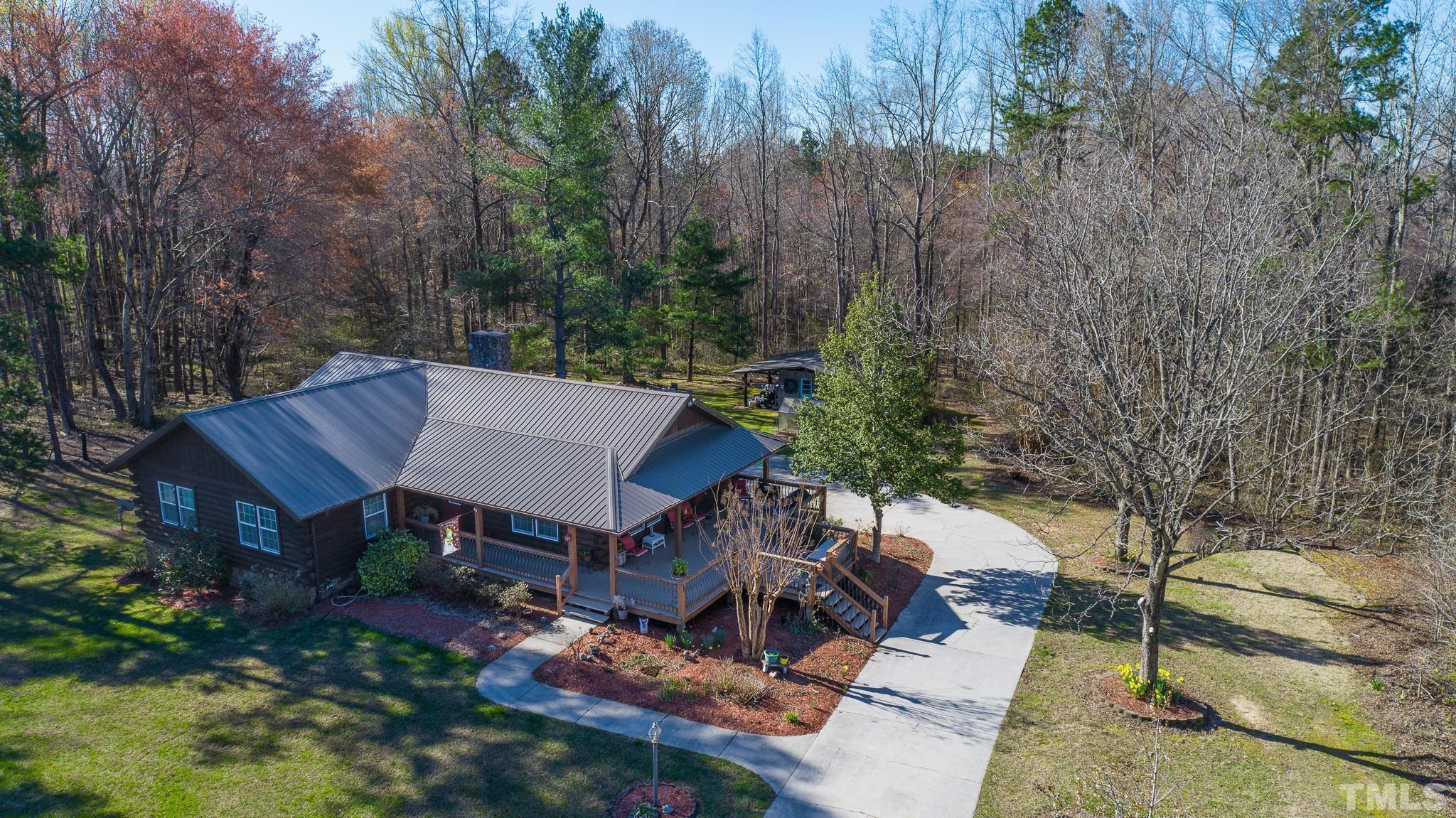 714 Lucy Garrett Road Roxboro, NC 27574 - Photo 58 of 68 an aerial view of a house with yard and mountain view in back