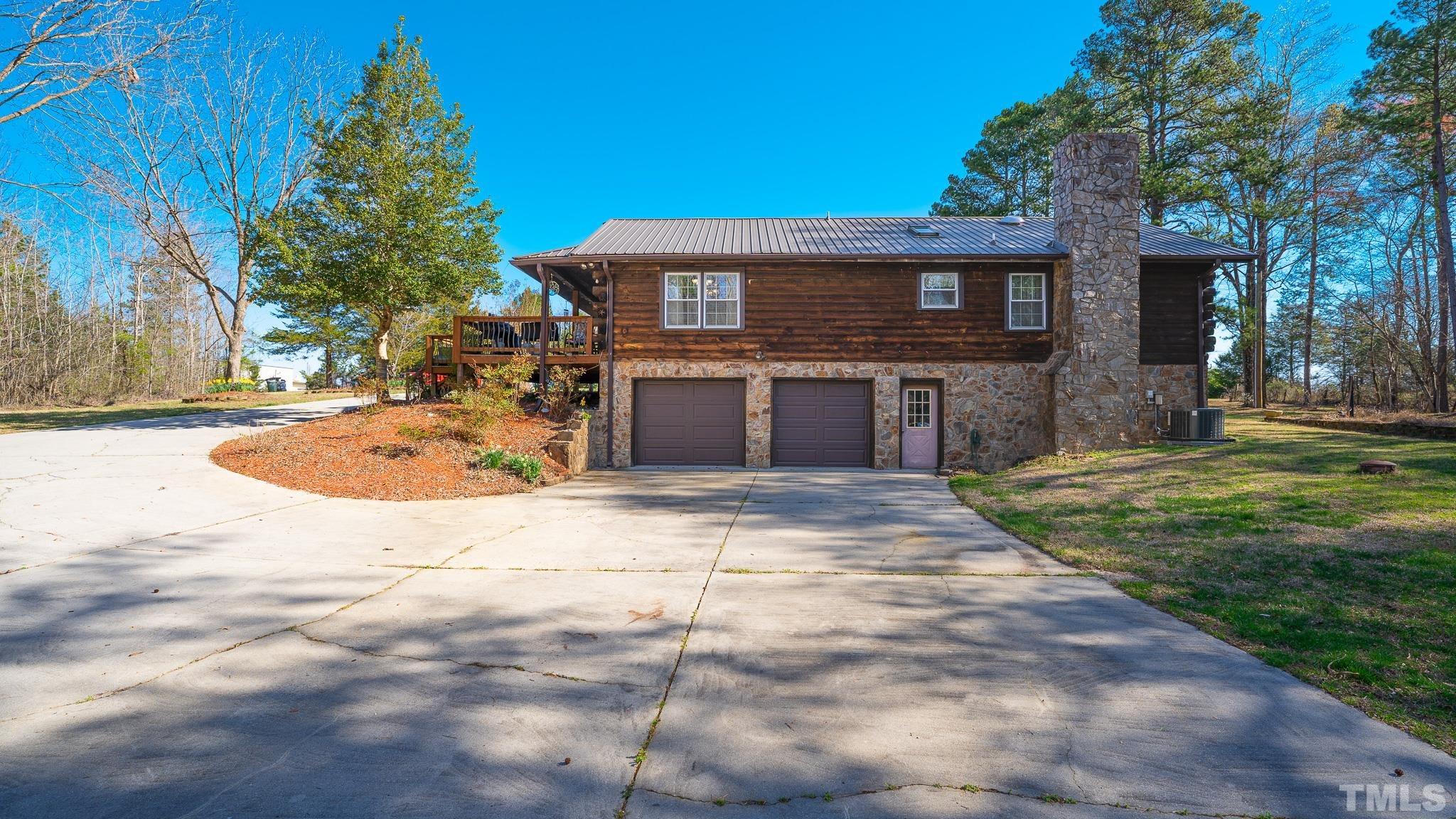 714 Lucy Garrett Road Roxboro, NC 27574 - Photo 64 of 68 a front view of a house with a yard and garage