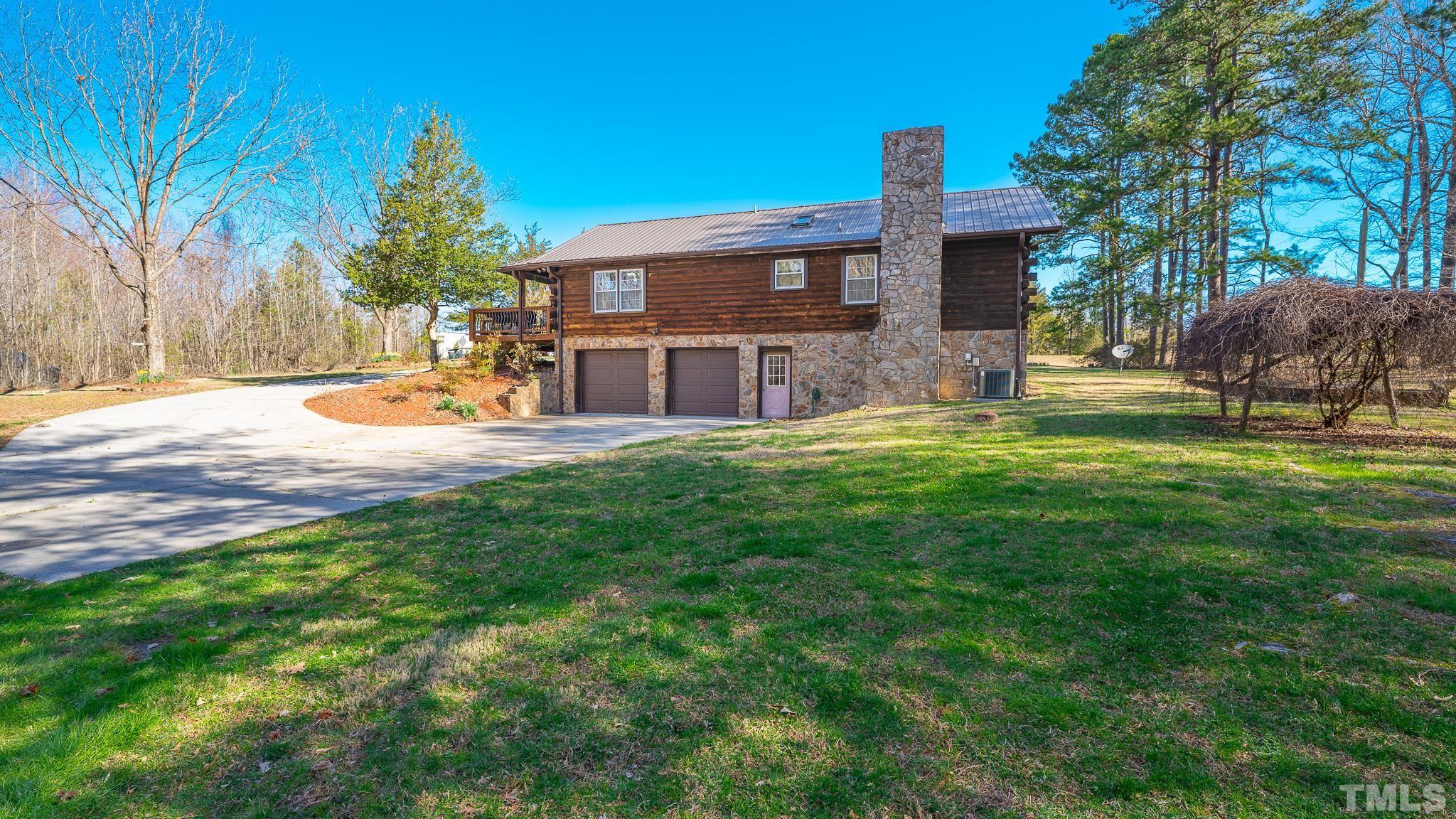 714 Lucy Garrett Road Roxboro, NC 27574 - Photo 65 of 68 a view of a house with a yard and sitting area