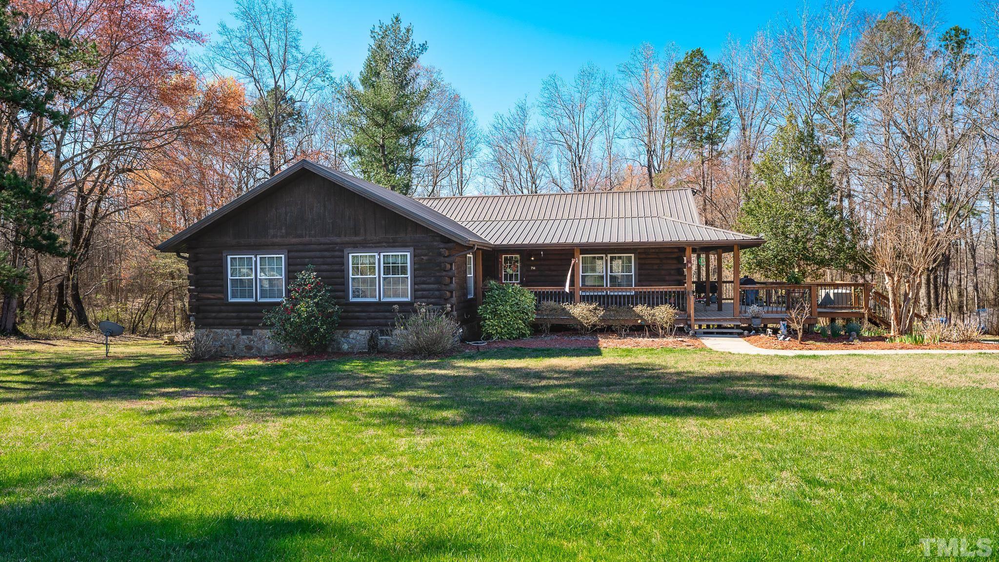 714 Lucy Garrett Road Roxboro, NC 27574 - Photo 67 of 68 a front view of a house with a garden