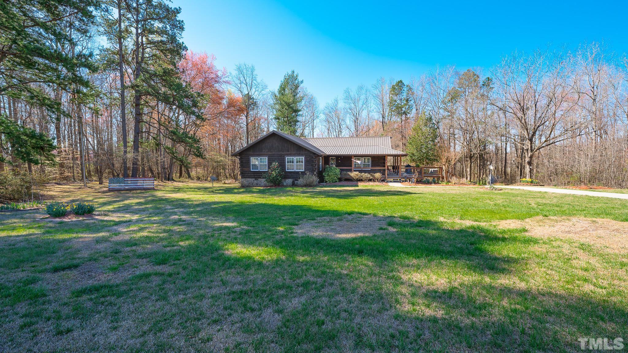 714 Lucy Garrett Road Roxboro, NC 27574 - Photo 68 of 68 a front view of a house with garden and trees
