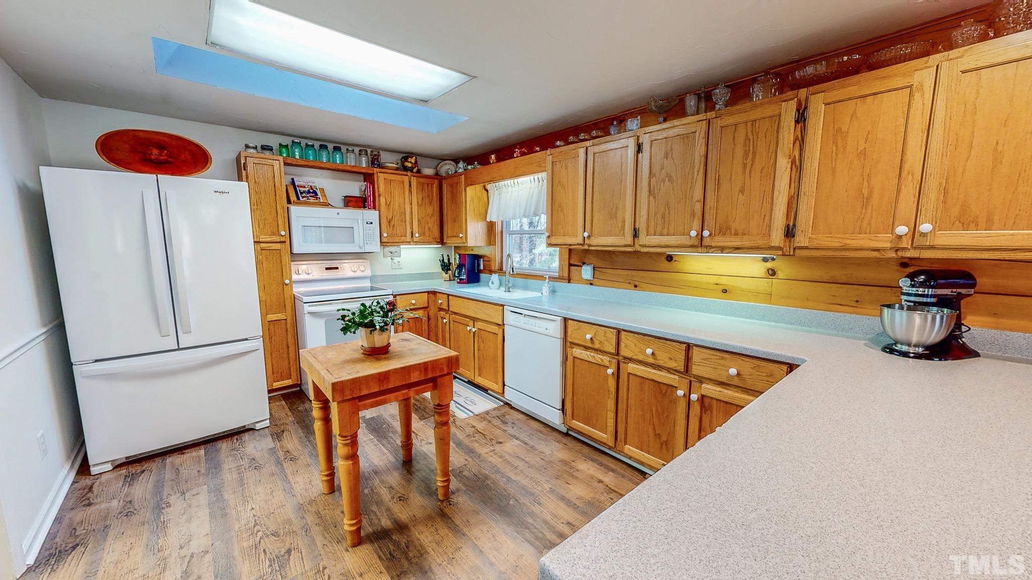 714 Lucy Garrett Road Roxboro, NC 27574 - Photo 9 of 68 a kitchen with stainless steel appliances granite countertop a refrigerator a sink and a stove