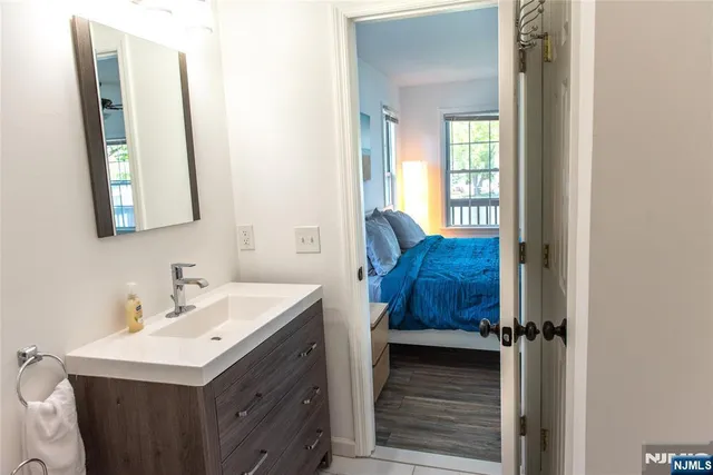 a bathroom with a sink vanity and a mirror