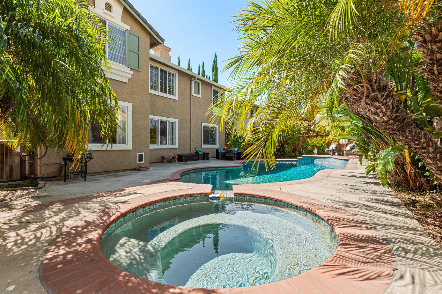 a swimming pool with outdoor seating and yard