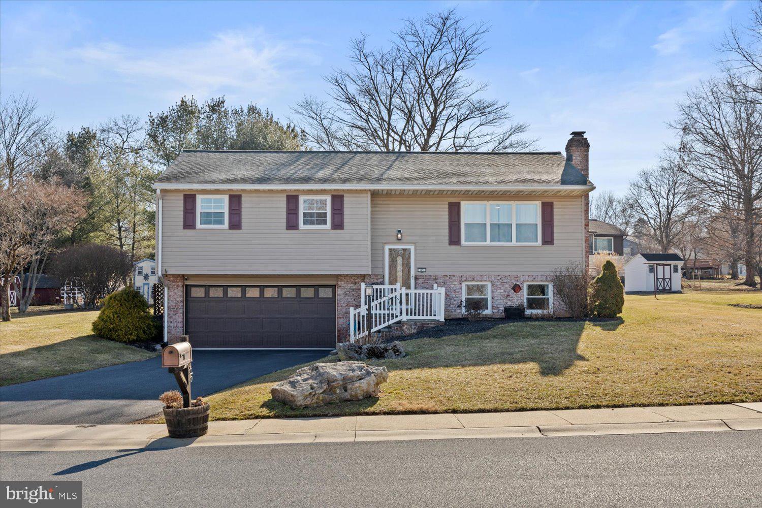45 Heritage Road Akron, PA 17501 - Photo 1 of 56 a front view of a house with garden