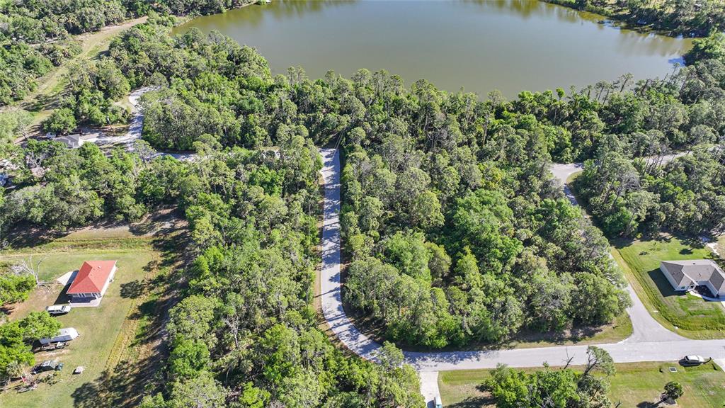 Longwell Ln Port North Port, FL 34286 - Photo 7 of 13 an aerial view of a house with a yard and lake view