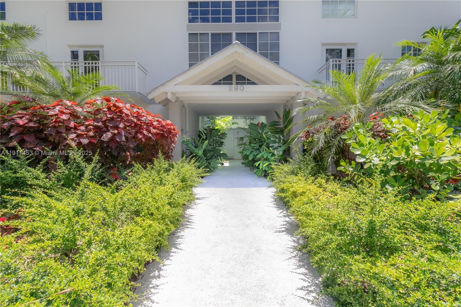 290 Sunrise Drive, Unit 3F Key Biscayne, FL 33149 - Photo 17 of 19 a front view of a house with a yard and potted plants