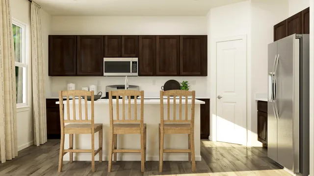 a kitchen with cabinets and refrigerator