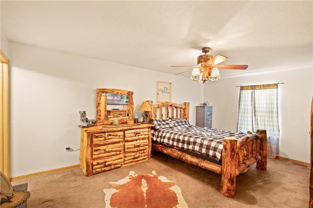 5164 Lincoln Highway Stoystown, PA 15563 - Photo 13 of 50 a bedroom with a bed and a chandelier