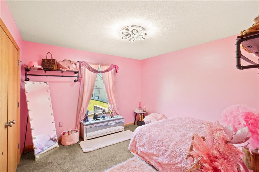 5164 Lincoln Highway Stoystown, PA 15563 - Photo 16 of 50 a bedroom with pink walls and bed