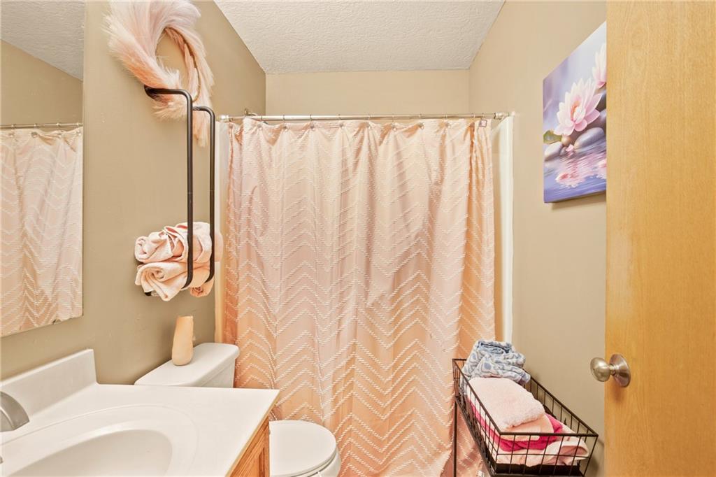 5164 Lincoln Highway Stoystown, PA 15563 - Photo 17 of 50 a bathroom with a sink toilet and shower curtain