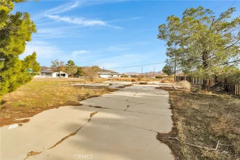 a view of a yard with wooden fence