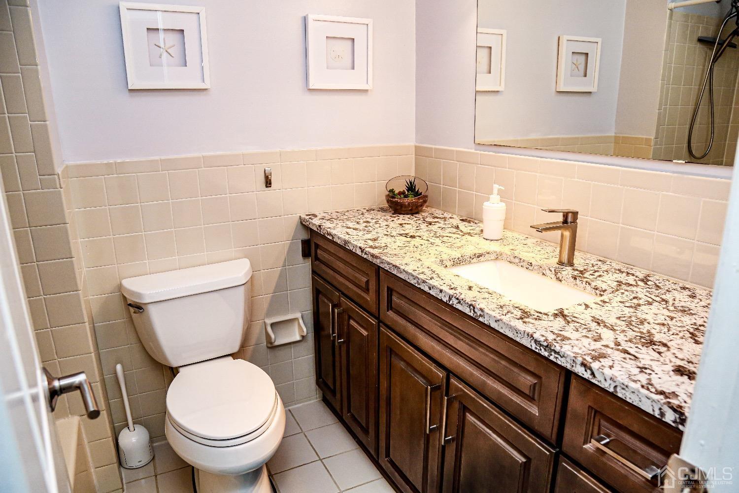 5805 Hana Road Edison, NJ 08817 - Photo 34 of 40 a bathroom with a granite countertop toilet sink and mirror