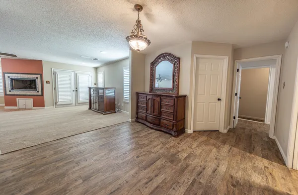 a living room with furniture a dining table and kitchen view