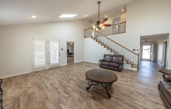 a view of a livingroom with furniture staircase and a kitchen